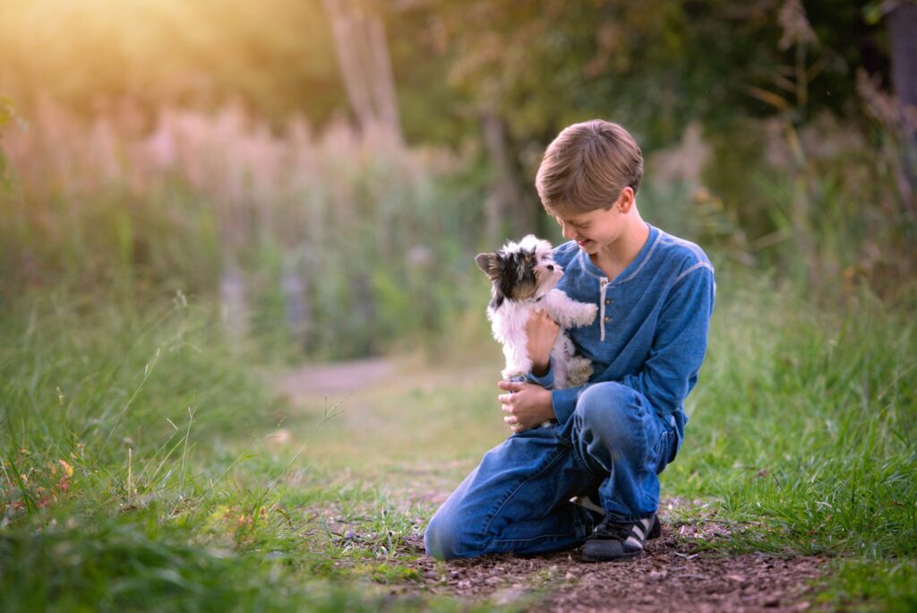 Boy and yorkshire terrier outdoor portrait