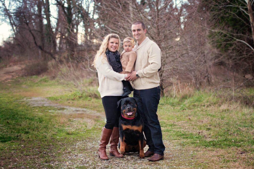 Family and rottweiler outdoor portrait